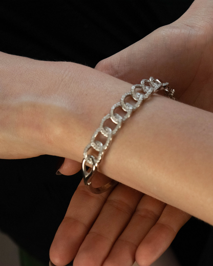Fashion-forward look featuring Goldmacher Cuban Link Bracelet styled with layered rings
