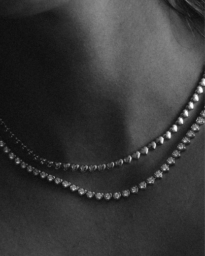 Goldmacher Lover’s Line Necklace – Romantic silver heart chain styled on model with soft, elegant neckline fit