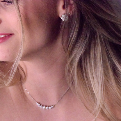 Model wearing the Goldmacher Felis Silver 925 graduated bar necklace with 0.5ct round moissanite stones