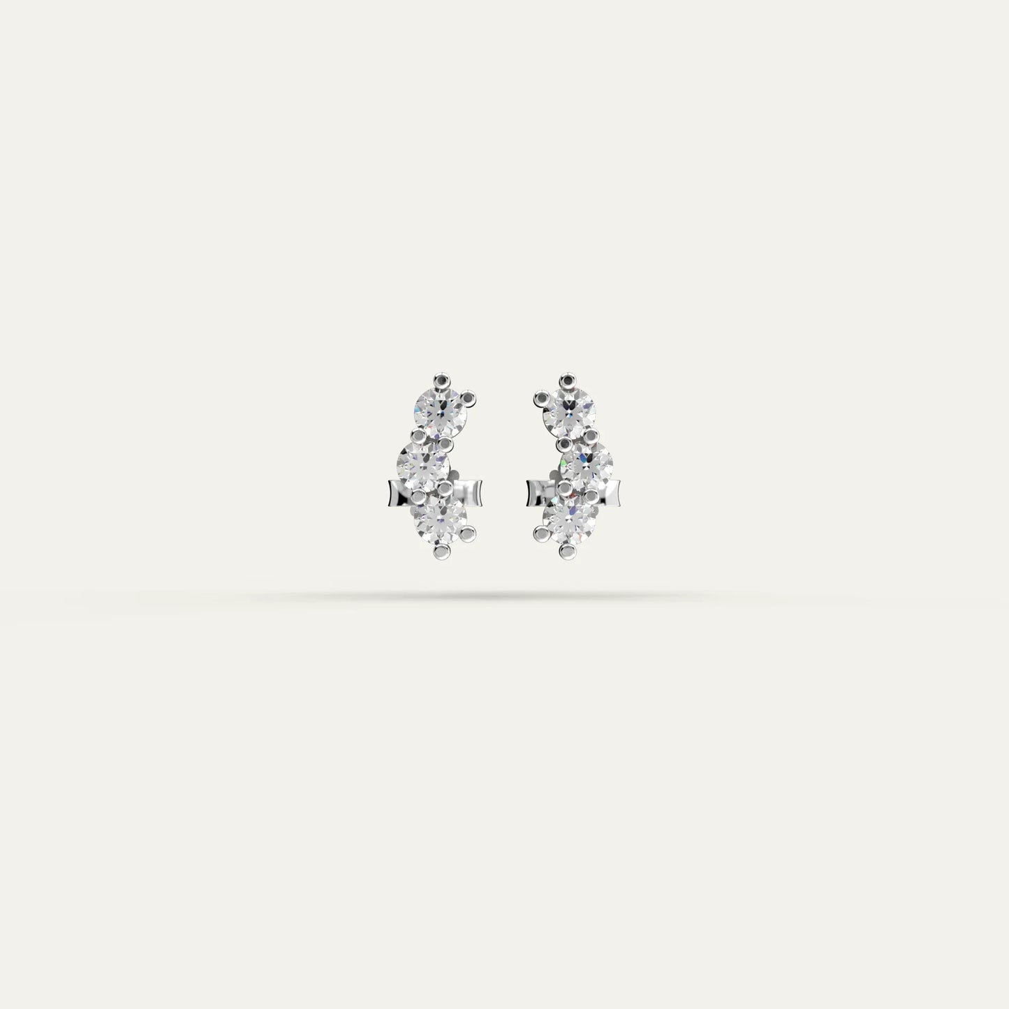 Goldmacher Orio earrings in 925 silver with multiple round moissanite stones in a curved ear climber design.