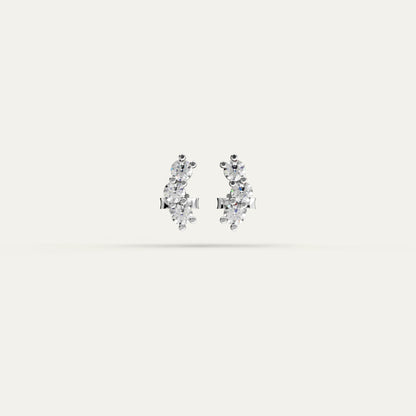 Goldmacher Orio earrings in 925 silver with multiple round moissanite stones in a curved ear climber design.